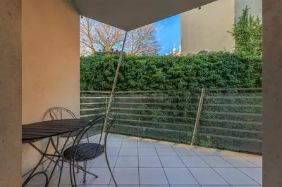a table and chair on a patio with stairs at plac Na Groblach 5 by Homeprime in Kraków