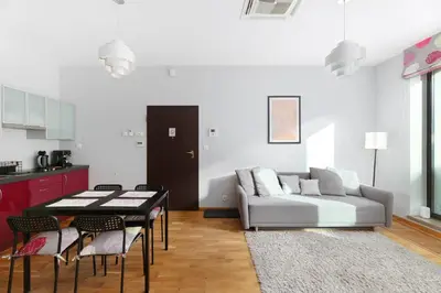 a living room with a couch and a table at plac Na Groblach 5 by Homeprime in Kraków