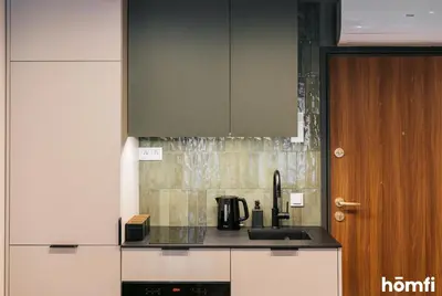 a kitchen with a sink and a stove top oven at Smolensk Loft Suite - homfi Collection in Kraków