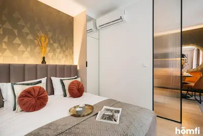 a bathroom with a sink and a toilet and a shower at Smolensk Loft Suite - homfi Collection in Kraków