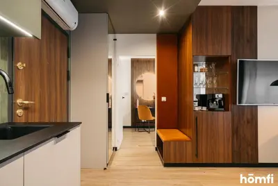 a living room with a couch and a table at Smolensk Loft Suite - homfi Collection in Kraków