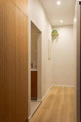 a hallway of a home with a large wooden closet at Krupnicza 12 in Kraków
