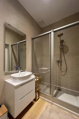 a bathroom with a sink and a shower at Krupnicza 12 in Kraków