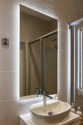 a white bathroom with a sink and a mirror at Krupnicza 12 in Kraków
