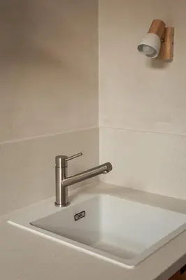a sink in a kitchen with a silver faucet at Krupnicza 12 in Kraków