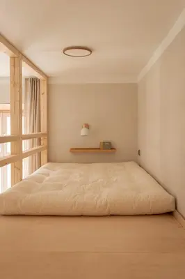 a bedroom with a large bed with a window at Krupnicza 12 in Kraków