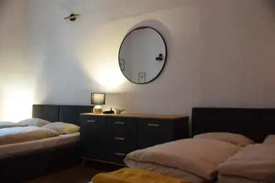 a bedroom with two beds and a mirror on the wall at Apartment Tomasza 8 in Kraków