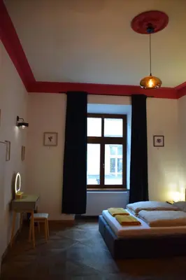 a bedroom with a bed and a large window at Apartment Tomasza 8 in Kraków