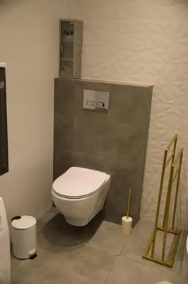 a bathroom with a white toilet in a room at Apartment Tomasza 8 in Kraków