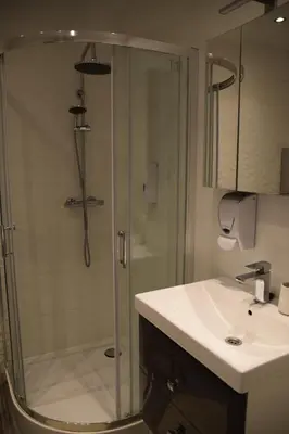 a bathroom with a shower and a sink at Apartment Tomasza 8 in Kraków