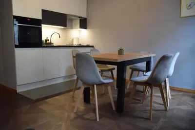 a kitchen with a table and chairs in a room at Apartment Tomasza 8 in Kraków