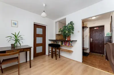 a kitchen and dining room with a table and a desk at Odrzańska Urban Jungle Apartment by BookingHost in Kraków