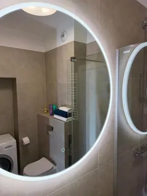 a bathroom with a shower and a toilet and a mirror at Rakowicka Krakow City Center Premium Apartment with Balcony near Main Station in Kraków