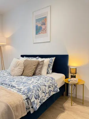 a bedroom with a blue and white bed and a lamp at Rakowicka Krakow City Center Premium Apartment with Balcony near Main Station in Kraków