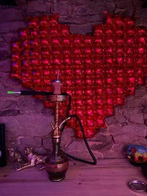 a red lamp with a wall of red roses at Domek na szlaku 70 in Skomielna Biała