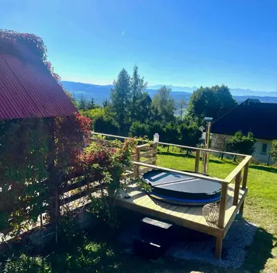 a wooden deck with a swimming pool in a yard at Domek na szlaku 70 in Skomielna Biała