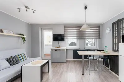 a living room with a couch and a table at Podgórze Pleasant Apartment by BookingHost in Kraków