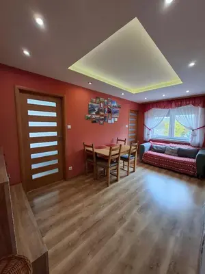 a living room with a table and a couch at Mieszkanie na Jurze Południowej pod Krakowem in Krzeszowice