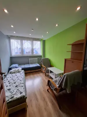 a bedroom with a bed and a desk and a table at Mieszkanie na Jurze Południowej pod Krakowem in Krzeszowice