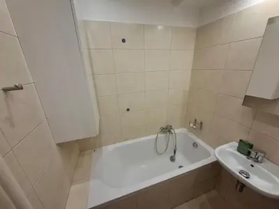 a bathroom with a white tub and a sink at Mieszkanie na Jurze Południowej pod Krakowem in Krzeszowice