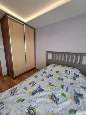 a bedroom with a bed with a colorful comforter at Mieszkanie na Jurze Południowej pod Krakowem in Krzeszowice