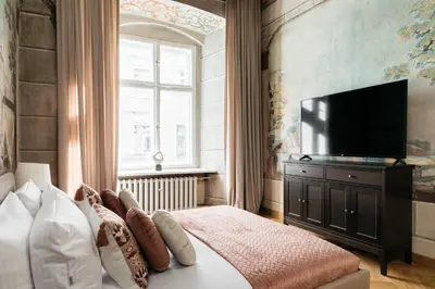 a living room with a couch and a table at Fresco Residence by Tyzenhauz in Kraków