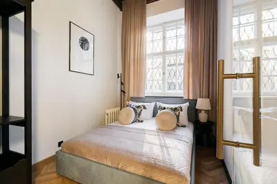a living room with a couch and a table at Fresco Residence by Tyzenhauz in Kraków