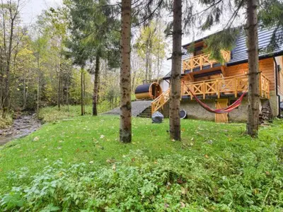 a log cabin with a playground in the woods at Zawoja domek do wynajęcia in Zawoja