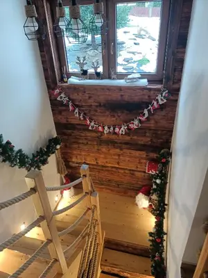 a stairway with a christmasreath and a window at Zawoja domek do wynajęcia in Zawoja