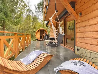 a porch with two hammocks on a cabin at Zawoja domek do wynajęcia in Zawoja