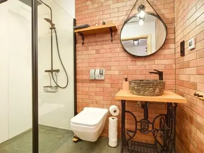 a bathroom with a sink and a toilet and a mirror at Zawoja domek do wynajęcia in Zawoja