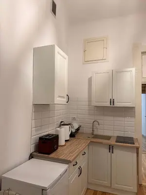 a kitchen with white cabinets and a sink at Meiselsa Residence in Kraków