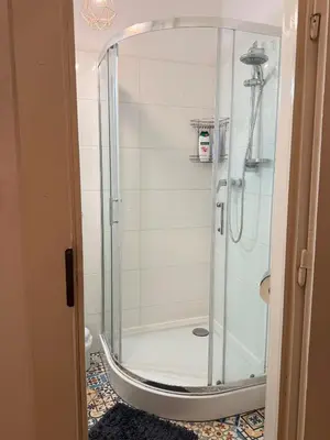 a shower with a glass door in a bathroom at Meiselsa Residence in Kraków