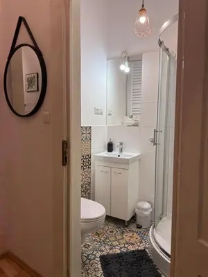 a bathroom with a toilet and a sink and a mirror at Meiselsa Residence in Kraków