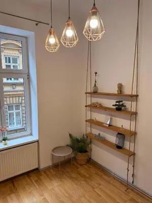 a room with three lights and a table and a window at Meiselsa Residence in Kraków