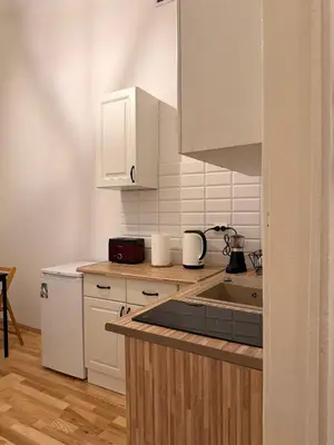 a kitchen with white cabinets and a sink at Meiselsa Residence in Kraków