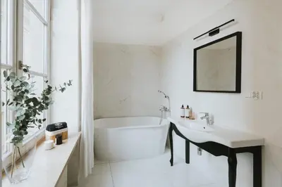 a white bathroom with a tub and a sink at Bogoria House in Kraków