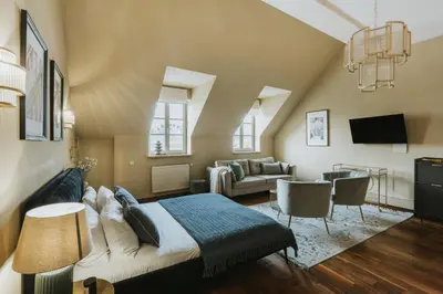 a bedroom with a bed and a living room at Bogoria House in Kraków