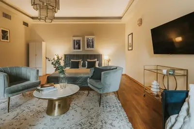 a living room with a bed and a table and chairs at Bogoria House in Kraków