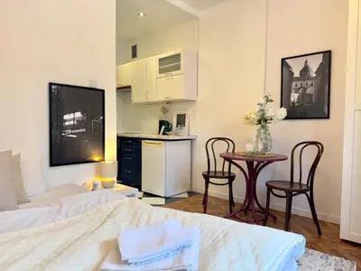 a bedroom with a bed and a table and chairs at Premium Studio - Free Parking - Near Old Town in Kraków