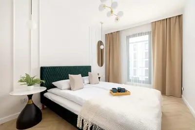 a bedroom with a large bed with a table on it at Stylowy Klimatyzowany Apartment Blisko Tauron Areny by Noclegi Renters in Kraków