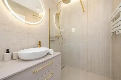 a white bathroom with a sink and a shower at Stylowy Klimatyzowany Apartment Blisko Tauron Areny by Noclegi Renters in Kraków