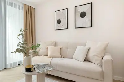 a white living room with a couch and a table at Stylowy Klimatyzowany Apartment Blisko Tauron Areny by Noclegi Renters in Kraków