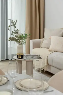 a living room with a couch and a table at Stylowy Klimatyzowany Apartment Blisko Tauron Areny by Noclegi Renters in Kraków