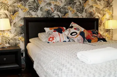 a bed with pillows on it in a bedroom at Cozy Old Town Apartments in Kraków