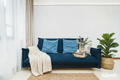 a bedroom with a bed with blue pillows at Smolensk Concept Residence - homfi Collection in Kraków