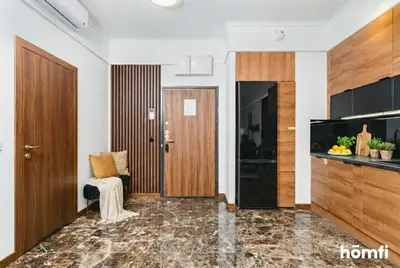 a corridor of a room with a door and a chair at Smolensk Concept Residence - homfi Collection in Kraków