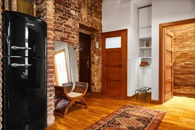 a kitchen with a black refrigerator and a chair at Loft Apartment Industrial Design in Kraków
