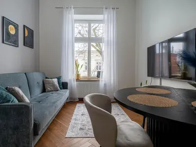 a bedroom with a large bed with a window at Apartament Mostowa in Kraków
