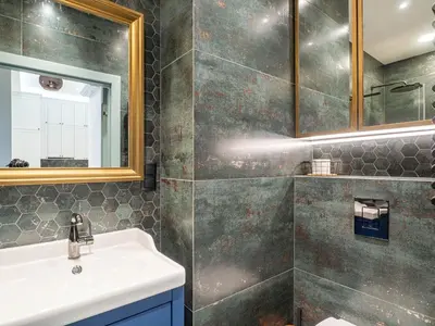 a bathroom with a sink and a mirror at Apartament Mostowa in Kraków